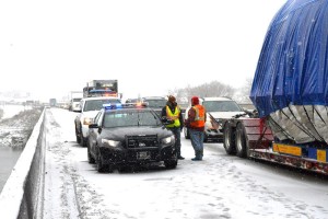 Montana Highway Patrol Trooper and others visiting while all traffic stops until the wreckage is moved off the Interstate. Traffic was down to one lane on the Yellowstone River bridge. (Jonathan McNiven photo) 