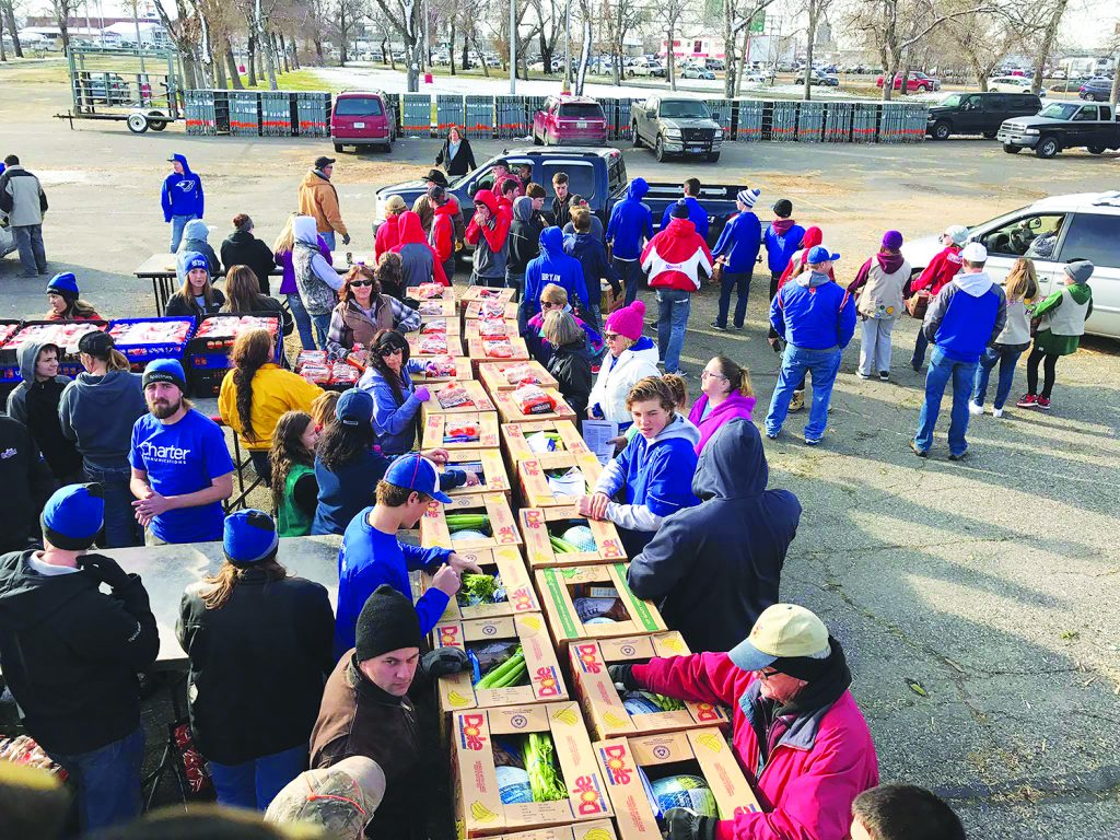 Students from Huntley Project Schools volunteered at the annual KCTR Flakesgiving prep on Friday at MetraPark. Students from wrestling, special education and FCCLA groups were on hand to help prepare meal boxes that will feed an estimated 10,000 people. Each box contains a 10-15 pound turkey, 10 pounds of potatoes, celery, onions, corn, stuffing, gravy mix, rolls and boxes of macaroni and cheese. (Photo courtesy of Scot Eenhulis)