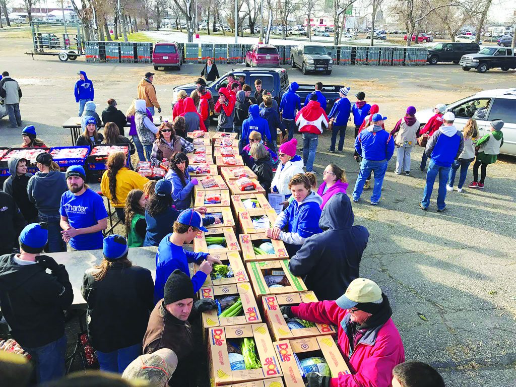 Students from Huntley Project Schools volunteered at the annual KCTR Flakesgiving prep on Friday at MetraPark. Students from wrestling, special education and FCCLA groups were on hand to help prepare meal boxes that will feed an estimated 10,000 people. Each box contains a 10-15  pound turkey, 10 pounds of potatoes, celery, onions, corn, stuffing, gravy mix, rolls and boxes of macaroni and cheese. (Photo courtesy of Scot Eenhulis)