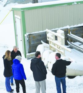 Gov. Steve Bullock, lower center in black coat, looks over the Lockwood's water intake at the Yellowstone River on Wednesday morning, accompanied by Mike Ariztia, Lockwood Water and Sewer District manager, at right. Also on the tour were Yellowstone County Commissioner Robyn Driscoll, in the blue coat, Jill Cook of Morrison Maierle Inc. and Tony Reed, at top left, the assistant manager of the water-sewer district. (Jonathan McNiven photo) 
